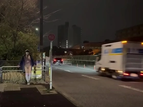 Yun-chan Femboy goes incognito in the afternoon behind bus stop advertisements on a public street.