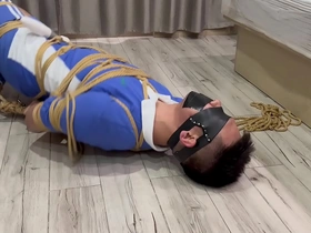 Asian man with short hair pleasure himself while being gagged and vibrated.