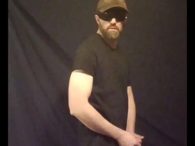 Half-naked gay man enjoying solo pleasure with ball strap tease