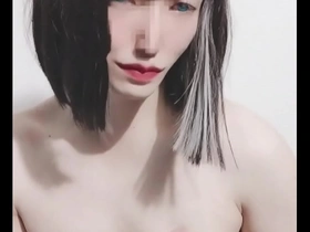 A feminine looking Japanese cross dresser in a BDSM scene.