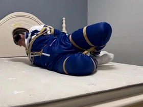 Asian boy in hogtie bondage with a blindfold and gag