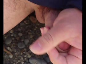 Gay Japanese man masturbates outdoors and cums on the beach