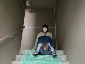Mayu Konka takes a selfie of her pantyhose on the stairs of her apartment.