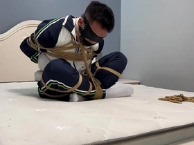 Young Asian man in white socks and Ebi-position bondage